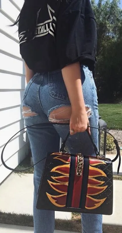 Kylie Jenner Metallica shirt and torn jeans combo