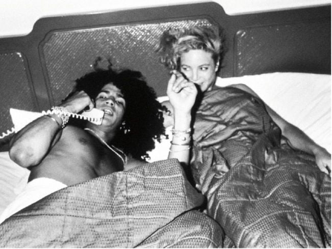 Slash in bed with a groupie. Guns N' Roses