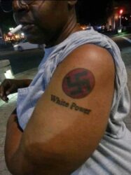 A Black man with Nazi Swastika and White Power tattoos