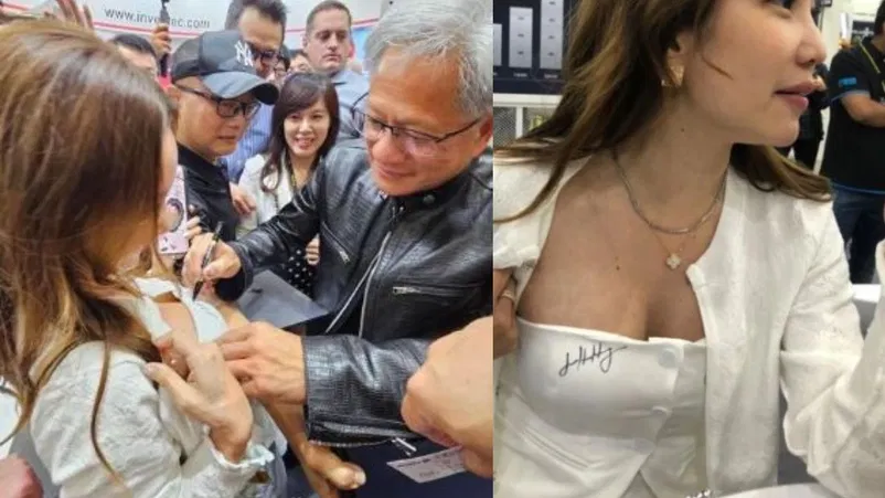 Nvidia CEO Jensen Huang signs autograph on fans chest